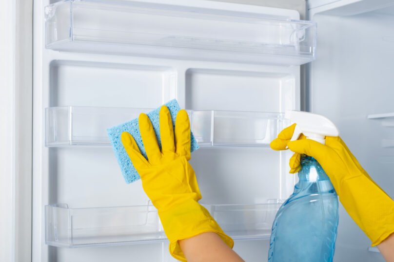Woman's,Hands,In,A,Yellow,Rubber,Protective,Glove,And,A